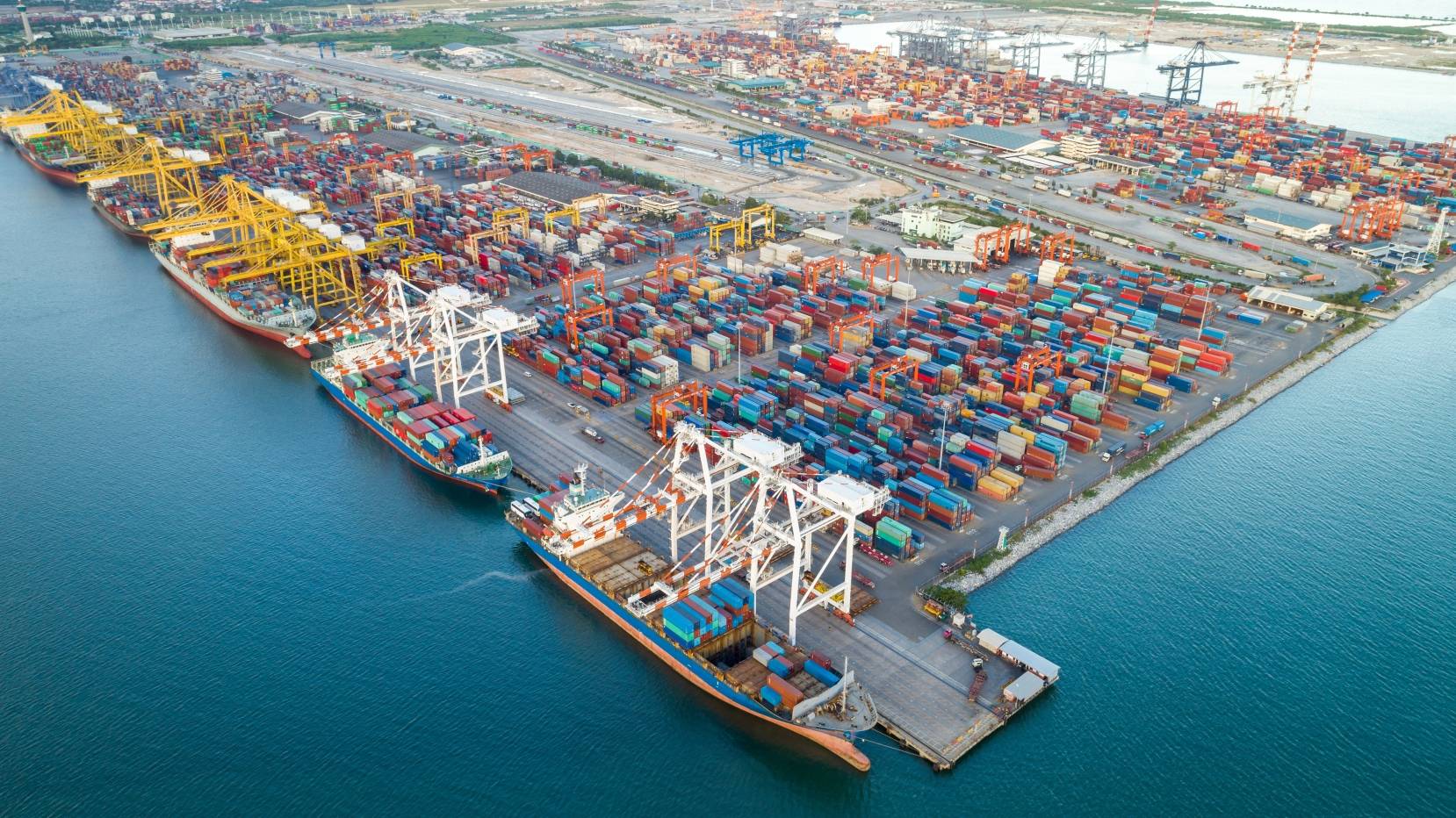 Container vessels and cranes operating at a major port terminal