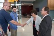 Apprentices Jason Marshall (left) and Matthew Stanley (center) greet Virginia Secretary of Education Anne Holton in the lobby of The Apprentice School before her tour led by the school’s director, Everett Jordan (right). Photo by Chris Oxley/HII