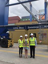 SCPA COO Barbara Melvin (from left), fifth grader Haven Ebel and SCPA CEO Jim Newsome stand beside the rubber-tired gantry crane Ebel named “Little Miss Sunshine" at Inland Port Greer.