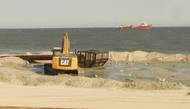 Bulldozers reconstruct the beach and dunes at Long Beach Island, New Jersey, as a dredge ship pumps sand from the Outer Continental Shelf to shore. Photo BOEM