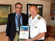 Chairman of the Canaveral Port Authority Commission Admiral Wayne Justice
presents welcome home plaque to Enchantment Captain Toni Tomljanovic
Photo: ©Port Canaveral