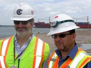 Crowley's Bleu Hilburn and Tony Ortiz in front of the company's chartered ship Vega (Photo courtesy of Crowley Maritime Corp.)