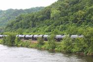 A crude oil train segment rumbles alongside a U.S. inland waterway. CREDIT: Dagmar Etkin