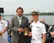 Ensign Jeffrey Iiams receives the Elmer A. Sperry Junior Navigator of the Year Award from Jeff Holloway of Northrop Grumman Corporation.