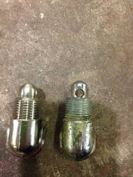 Figure 1: The obsolete diffuser on the right is cast differently than diffusers used today. Note the longer neck and placement of diffuser holes. The newer diffuser on the left is compatible with standard discharge hoses and has a shorter neck to allow it to properly seat when the hose is connected. See Figure 3 for how to determine if you have a CO2 extinguisher fitted with an obsolete diffuser that may be incompatible with standard industry discharge hoses.