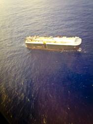 A team of four Guardian Angel pararescuemen from the 129th Rescue Wing, Moffett Federal Airfield, Calif., parachutes to the Green Ridge container ship during an over-water rescue mission Aug. 18, 2015.