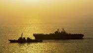 The guided-missile destroyer USS Roosevelt (DDG 80), left, and the amphibious assault ship USS Bataan (LHD 5) transit the Arabian Gulf. Bataan is the flagship for the Bataan Amphibious Ready Group and, with the embarked 22n