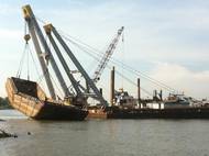 Inland Salvage Raises Scrap Metal Barge on the Mississippi River.