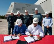 Jonathan Graves (sitting, left) and John Fillmore (sitting, right) sign the delivery documents: Photo credit HII