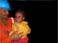 Crew members of the Synergy Managed bulker “Jupiter Bay” help two infants to safety who were among 322 people rescued from small overcrowded boats early on Saturday morning. Part of the humanitarian operation that the Italian Navy reports has seen the rescue of some 5200 people trying to cross from North African to Europe since Thursday June 5th. All 322 individuals were disembarked safely at the Italian Port of Pozzallo, Sicily on Saturday evening (7th).