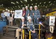 Paul and Nancy Ignatius (seated); also pictured (left to right): Lance Carnahan, Robert Velazquez, David Ignatius, Dr. Elisa Ignatius, Sarah Ignatius, George Nungesser, Capt. Mark Vandroff, Cmdr. Ben Wilder and Rear Adm. David J. Gale. (Photo by Lance Davis/HII)