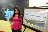 Paola Dominguez with a rendering of the new Marlin Class ship. The Isla Bella will enter service in the 4th quarter of 2015. (Photo courtesy of Sea Star Line)