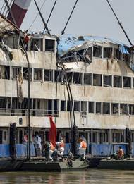 In this photo released by China's Xinhua News Agency, rescuers work in the hull of the upright Eastern Star ship to launch rescue work in the section of Jianli on the Yangtze River, central China's Hubei Province Saturday,