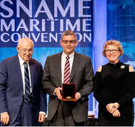 HII President and CEO Mike Petters, center, accepts the 2019 Vice Admiral Emory S. “Jerry” Land Medal from, at left, Fred Harris, former president of General Dynamics NASSCO and Bath Iron Works, and Suzanne Beckstoffer, president of Society of Naval Architect and Marine Engineers (SNAME). The Land Medal is presented to an individual for outstanding accomplishment in the marine field. Photo courtesy of SNAME