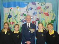 Royal Navy Veteran Roy Ticehurst with pupils from Woodmansterne Primary School Helen Marshall, James Stephenson, Azura Stones and Dylan Brown, all aged 11