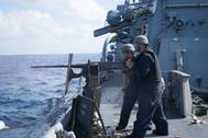 Sailors aboard Arleigh Burke-class guided-missile destroyer USS Curtis Wilbur (DDG 54) fire a M2HB .50-caliber machine gun during a gunnery exercise in the South China Sea. Curtis Wilbur is on patrol in the 7th Fleet area of responsibility in support of security and stability in the Indo-Asia-Pacific region. (U.S. Navy photo by Lt.j.g. Jonathan Peterson/Released)