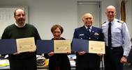 Stephen Stewart, Elizabeth Nebei and Coast Guard auxiliarist Norman Raymond, crew members of the education vessel Clinton, are awarded the Captain David P. Dobbins Award by U.S. Coast Guard Capt. Jeff Ogden, commanding officer of Coast Guard Sector Detroit, Feb. 19, 2014.They received the award for saving two people in the Detroit River Aug. 11, 2013. (U.S. Coast Guard photo)