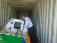 Victor Mooney of Queens, New York looks at the Spirit of Malabo inside a shipping container at the Haitian Coast Guard base in Cap Haitian today.