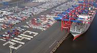 To welcome the world’s largest containership OOCL Germany in Wilhelmshaven, EUROGATE employees use containers to write the ships TEU capacity "21413" near the vessel’s berthing area (Photo: EUROGATE)