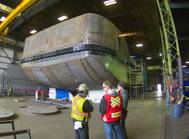 A worker’s torch cuts metal in the raised forecastle that will house the pin rooms. (Photo: Haig-Brown/Cummins)