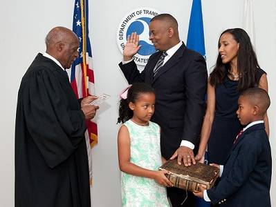 Anthony Foxx is sworn in as U.S. Secretary of Transportation by Judge Nathaniel Jones with wife, Samara, and children, Hillary and Zachary.