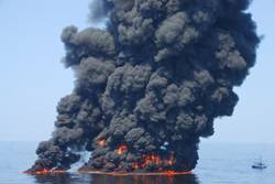 Black smoke billows from a controlled burn of surface oil during the 2010 Deepwater Horizon oil spill. A new study by NOAA and the Cooperative Institute for Research in Environmental Sciences (CIRES) found that controlled burns released more than one million pounds of sooty black carbon into the atmosphere.