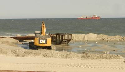 Bulldozers reconstruct the beach and dunes at Long Beach Island, New Jersey, as a dredge ship pumps sand from the Outer Continental Shelf to shore. Photo BOEM