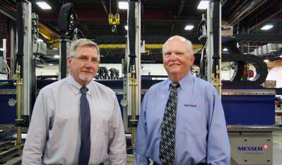 Bill Heller (left), new President and CEO of Messer Cutting Systems; and retiring President and CEO Gary Norville. In the Background is Messer’s Titan III Cutting Machine