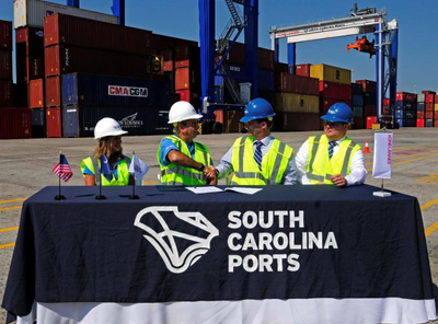 From left, SC Ports Authority Senior Vice President of Operations and Terminals Barbara Melvin and CEO Jim Newsome celebrate the purchase of 26 rubber-tired gantry cranes with Konecranes representatives Mika Mahlberg, Executive Vice President of Port Solutions and Jussi Suhonen, Regional Sales Director Americas, Port Solutions. (Photo: SCPA)