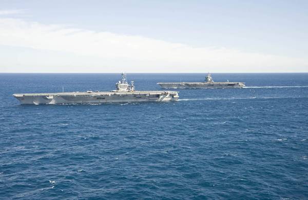 The aircraft carrier USS Enterprise (CVN 65) passes the aircraft carrier USS Harry S. Truman (CVN 75) in the Atlantic Ocean. (U.S. Navy photo by Naval Aircrewman (Tactical Helicopter) 3rd Class Matt Ballard/Released) 