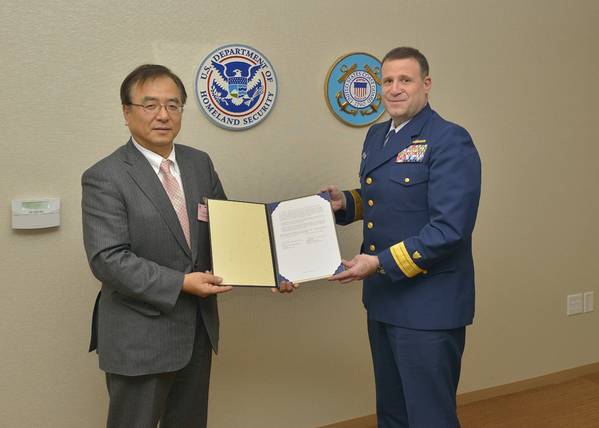 ClassNK Executive Vice President Dr. Takuya Yoneya (L) receives a copy of the Recognized Organization Agreement from U.S. Coast Guard Rear Admiral Joseph A. Servidio (R)