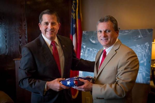 Congressman Buddy Carter presents outgoing GPA Executive Director Curtis Foltz (left) with a U.S. flag that has flown over the capitol in Washington D.C. Carter recognized Foltz' service to the state of Georgia during his final board meeting before stepping down June 30. (Photo: Georgia Ports Authority)