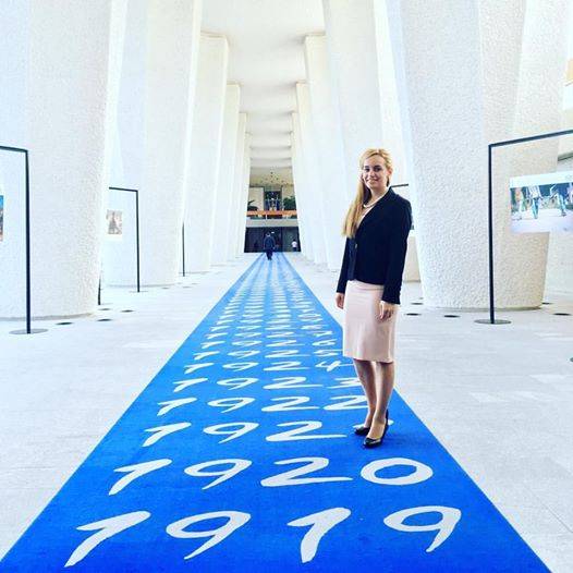 Eleni Antoniadou on ILO’s ‘blue carpet’ with dates going back to the establishment of the organization (Photo: ILO)