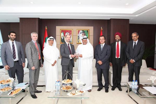 VP Global LNG receiving a memento from Khamis Juma Buamim, Chairman of Drydocks World & Maritime World