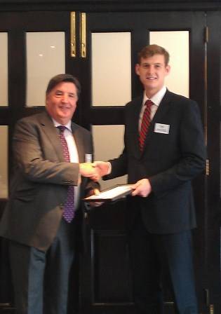 James Temple (right) receiving his certificate from Mr Archie Bethel CBE