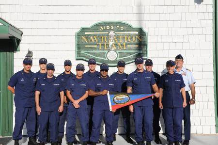 Crew members stationed at Aids to Navigation Team Jacksonville Beach Fla., and Capt. Tom Allan, commander of Sector Jacksonville, display the Sumner I. Kimball Award for excellence during an award ceremony held at the unit Friday, Aug. 9, 2013. (U.S. Coast Guard photo by Petty Officer 3rd Class Anthony L. Soto)