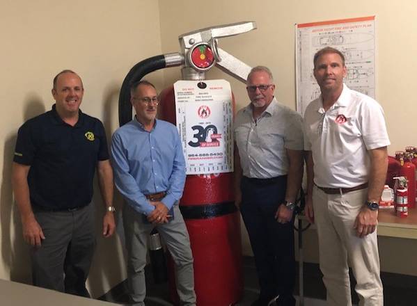 New Resolve Partners Chauncey Naylor (director of the Resolve  Academy), Stacy Payne (Resolve) and Glyn Day and Neil Cooper both with Fire Ranger.
The Large Fire Extinguisher is called Big Red. (Image: Resolve Marine)
