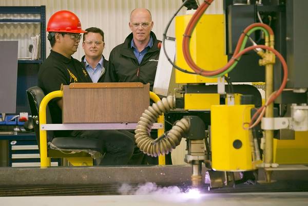 (left to right) Vancouver Shipyard’s Chester Saret - Burning Area Chargehand, Brian Carter – President, Seaspan Shipyards, and Mike Corrigan – President & CEO, BC Ferries, oversee the first cut of steel on the new BCFS Cable Ferry.