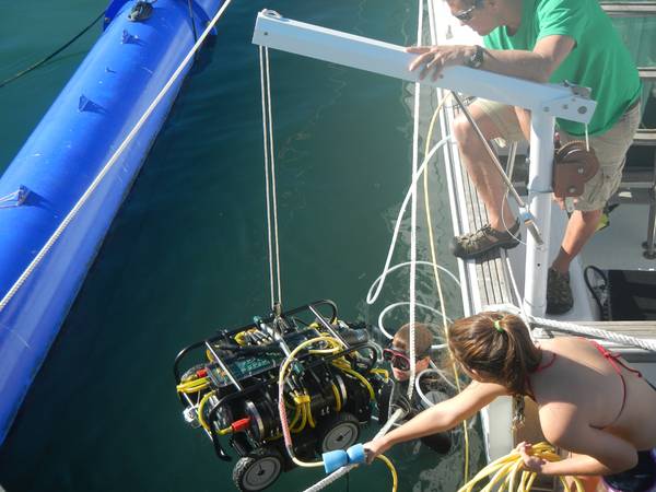 SeaRobotics’ HullBUG is lowered into the water for a field test.