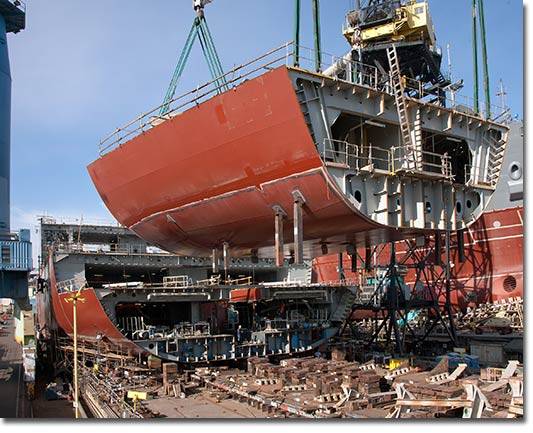 A section of the hull of the USNS Medgar Evers (T-AKE 13) lowered into place in January of 2011.