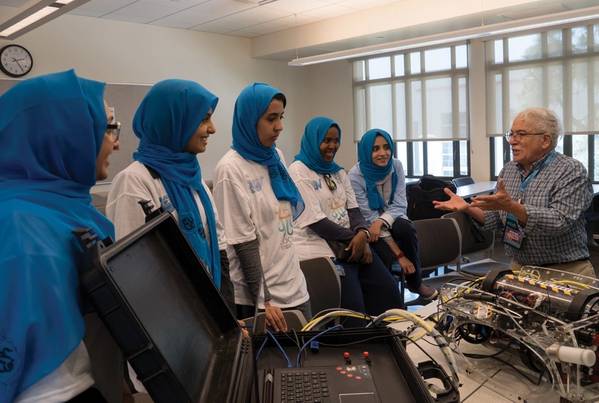 Side scan sonar inventor and long-time MATE competition judge and supporter Marty Klein speaks to the all-female ROV team from Saudi Arabia during the 2017 international event. Photo courtesy MATE II