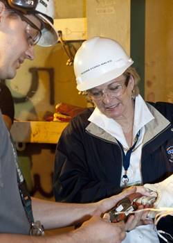 Susan Ford Bales receives a lesson in connecting instrumentation wiring during her Oct. 11 visit to Newport News Shipbuilding. (Photo: Huntington Ingalls Industries)