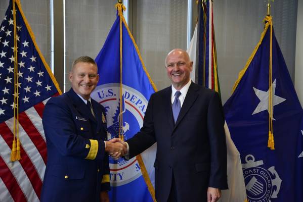 Rear Adm. Paul Thomas shakes hands with Captain Blaine Collins, DNV GL vice president of group governmental and public affairs for the U.S., following the signing of the new memorandum of agreement. The MOA authorizes DNV GL to participate in the Alternate Compliance Program. (Photo: U.S. Coast Guard)