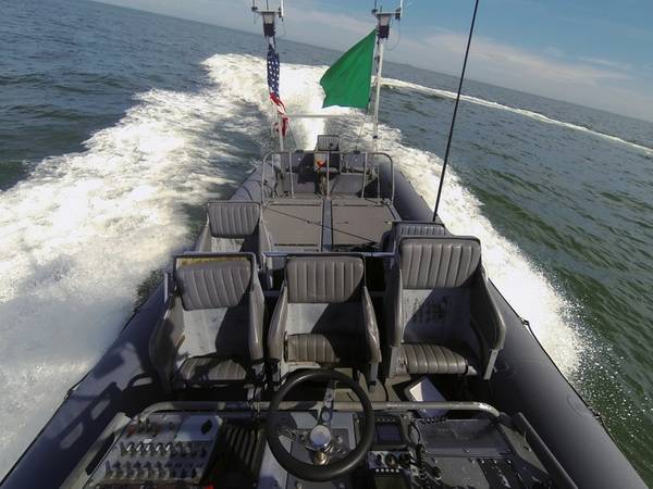 An unmanned rigid-hull inflatable boat operates autonomously during an Office of Naval Research (ONR)-sponsored demonstration of swarmboat technology held at Joint Expeditionary Base Little Creek-Fort Story. During the demonstration four boats, using an ONR-sponsored system called CARACaS (Control Architecture for Robotic Agent Command Sensing), operated autonomously during various scenarios designed to identify, trail or track a target of interest. (U.S. Navy photo by John F. Williams)
