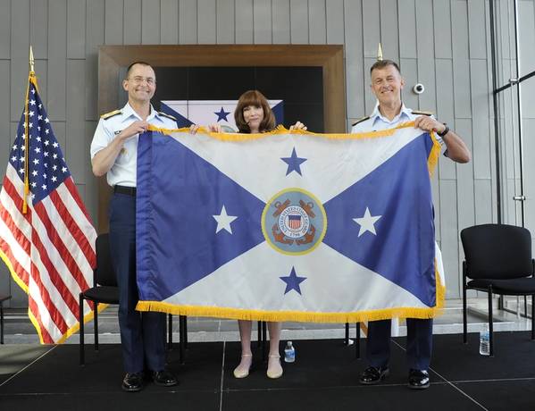 Adm. Zukunft (right), presents the new flag of the vice commandant of the Coast Guard to Adm. Charles at the conclusion of a ceremony at the Douglas Munro Coast Guard Headquarters Building in Washington, D.C., June 1, 2016. (U.S. Coast Guard photo by Kyle Niemi)