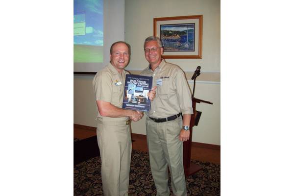 Ted Ackerstierna, Ted Ackerstierna, head of naval domain marketing and sales for Saab Electronic Defence Systems  thanks Captain Winton Smith, commanding officer of the U.S. Naval Base at San Diego, Calif., which served as the host for the 2012 Sea Giraffe Users Group.  Ackerstierna presented a signed copy of Naval Institute Guide to World Naval Weapon Systems by Dr. Norman Friedman.  Dr. Friedman was the keynote speaker for the first day of the three day Sea Giraffe User Group workshop. (Photo 