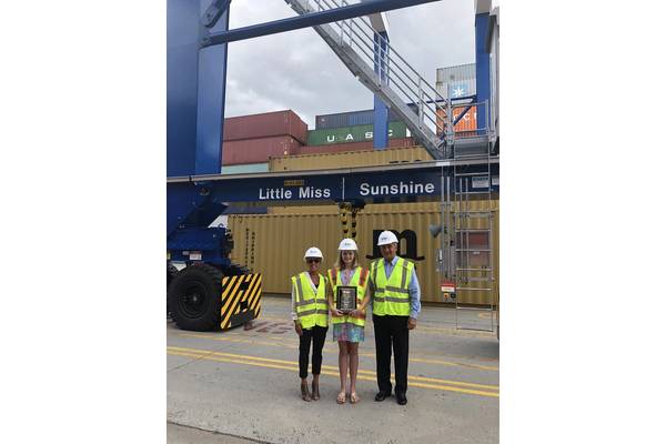 SCPA COO Barbara Melvin (from left), fifth grader Haven Ebel and SCPA CEO Jim Newsome stand beside the rubber-tired gantry crane Ebel named “Little Miss Sunshine" at Inland Port Greer.