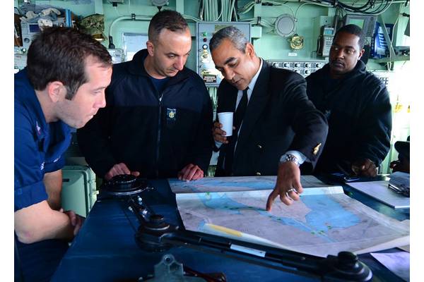 SUEZ CANAL (April 5, 2013) Egyptian pilot Mohamed El-Said shows Sailors a Suez Canal chart aboard the amphibious dock landing ship USS Carter Hall (LSD 50) as they begin a transit of the canal as part of the Kearsarge Amphibious Ready Group with the embarked 26th Marine Expeditionary Unit.  (U.S. Navy photo by Mass Communication Specialist 3rd Class Chelsea Mandello)