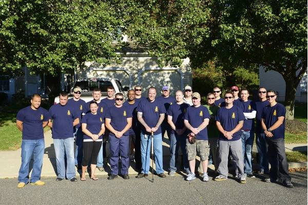 Chief Warrant Officer Richard Sambenedetto poses with 20 prospective chief petty officers outside his home in New Jersey, Monday, Oct. 12, 2015. The PCPOs helped out with landscaping and housework for Sambenedetto, who was diagnosed with myasthenia gravis. (U.S. Coast Guard photo by Chief Petty Officer Nick Ameen)