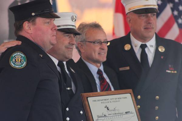 Bob Clark (second from right) from MetalCraft Marine presents the FDNY with a commemorative plaque. (Photo: Greg Trauthwein)